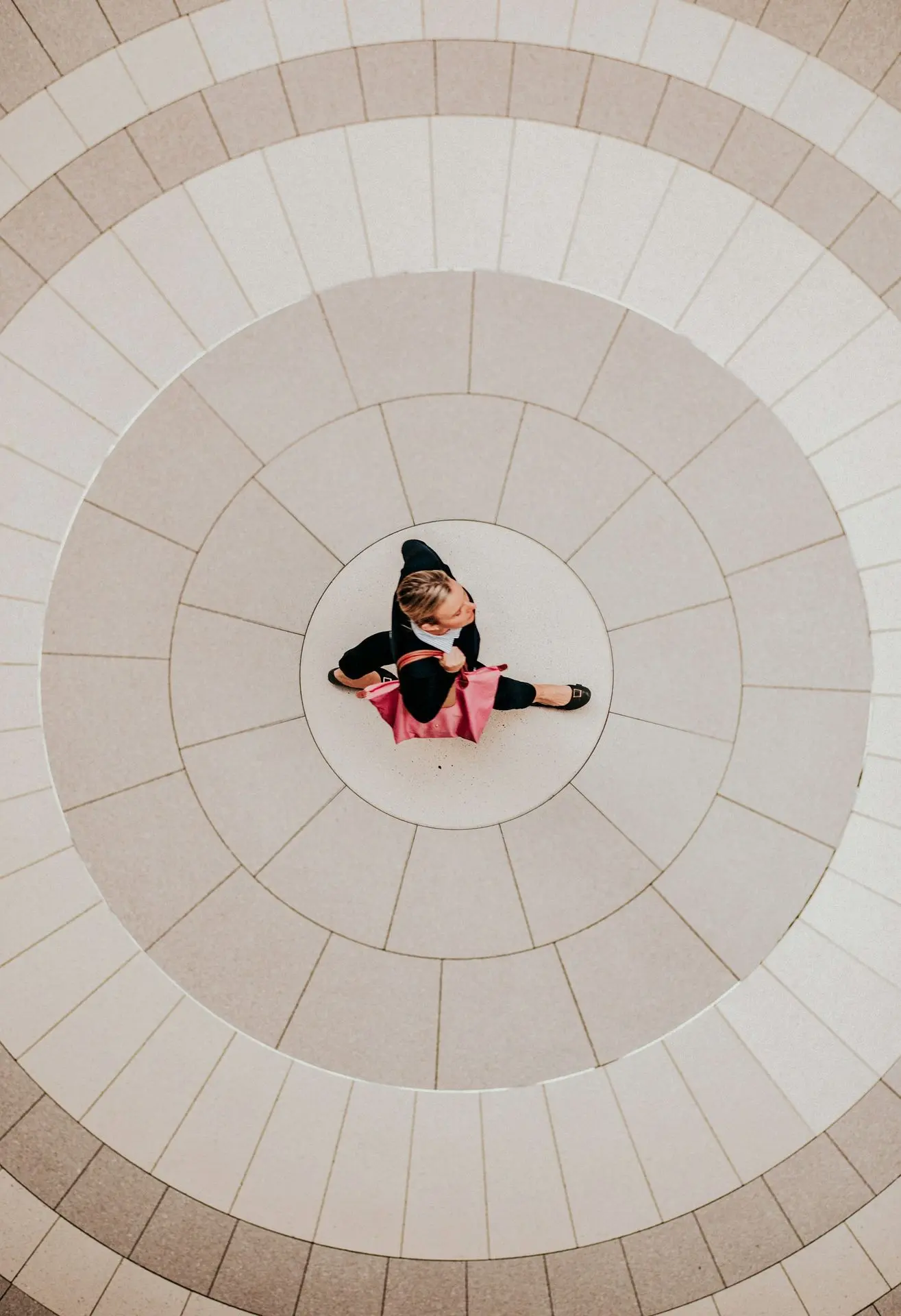 A woman walking across a circular tiled floor in Toronto